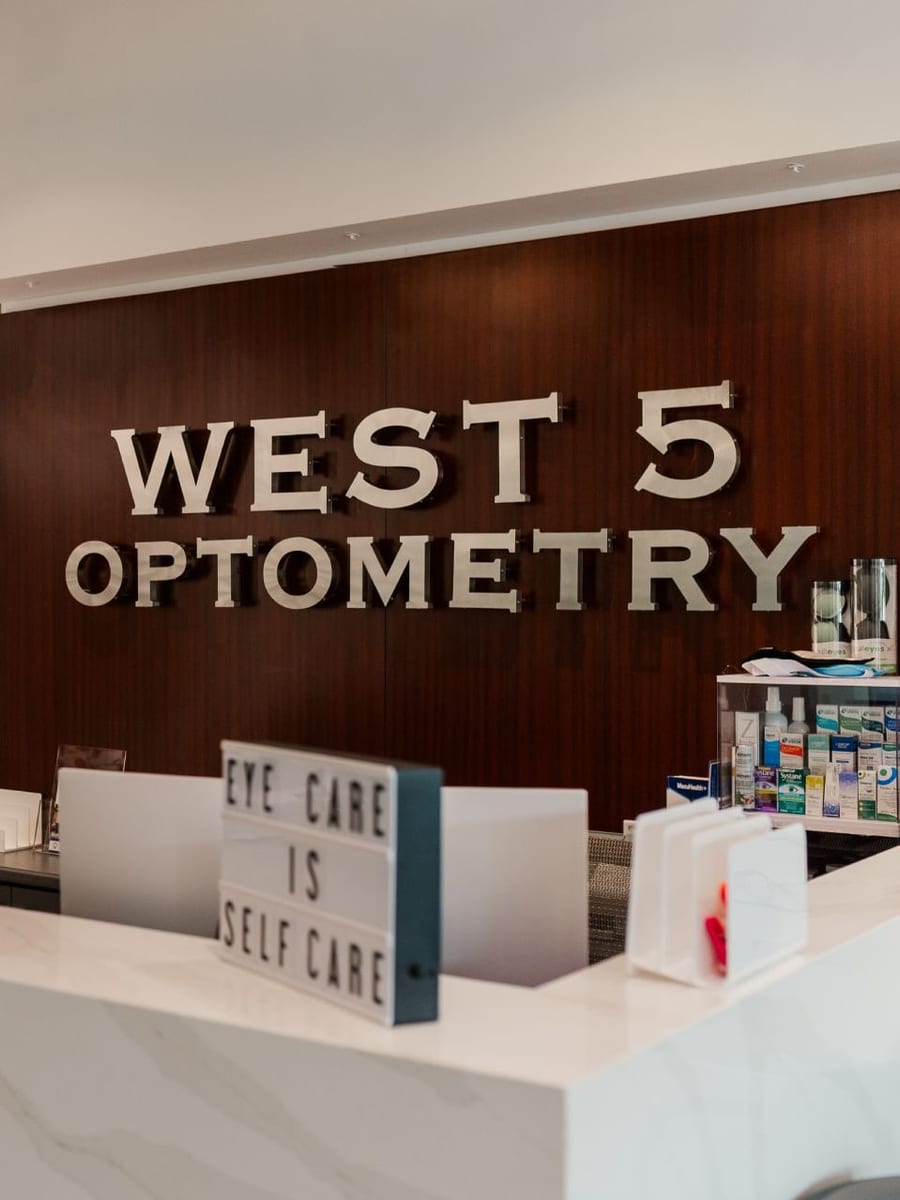 The West 5 Optometry sign on the reception wall of the practice